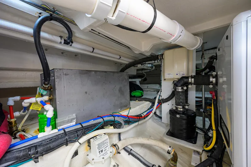 Slide: The Image of 2024 Cruisers Yachts GLS-OB engine room with pipes, wiring, and mechanical components. - 41
