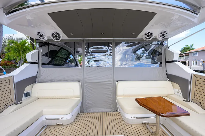 Slide: The Image of 2024 Cruisers Yachts GLS-OB interior with white seating and wooden table. - 43