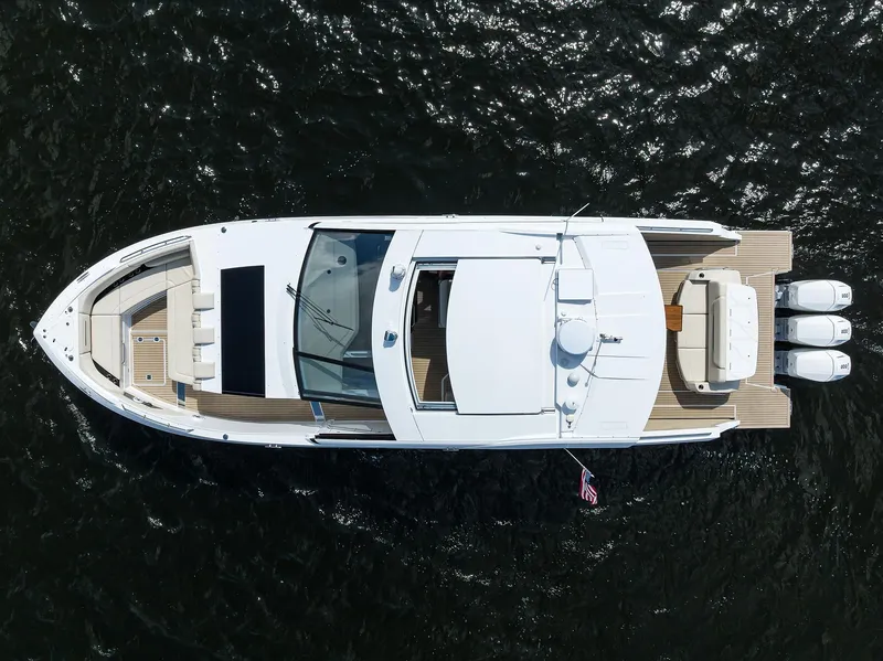 Slide: The Image of 2024 Cruisers Yachts GLS-OB, aerial view, sleek design, on dark water. - 46