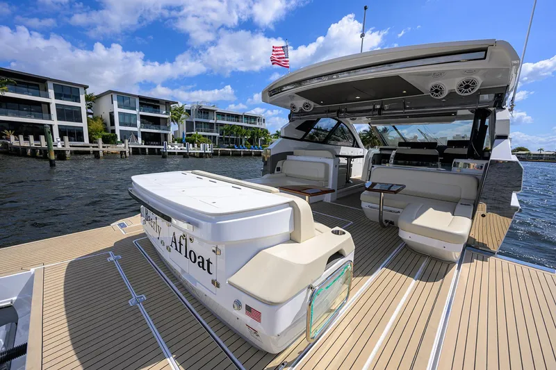 Slide: The Image of 2024 Cruisers Yachts GLS-OB on water, showcasing spacious deck and luxurious seating. - 6