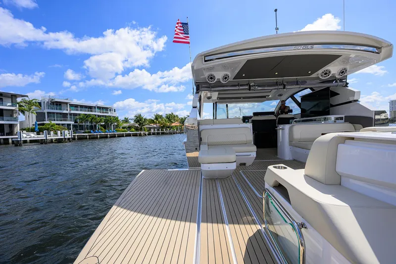 Slide: The Image of 2024 Cruisers Yachts GLS-OB on water, showcasing luxury deck and seating. - 9