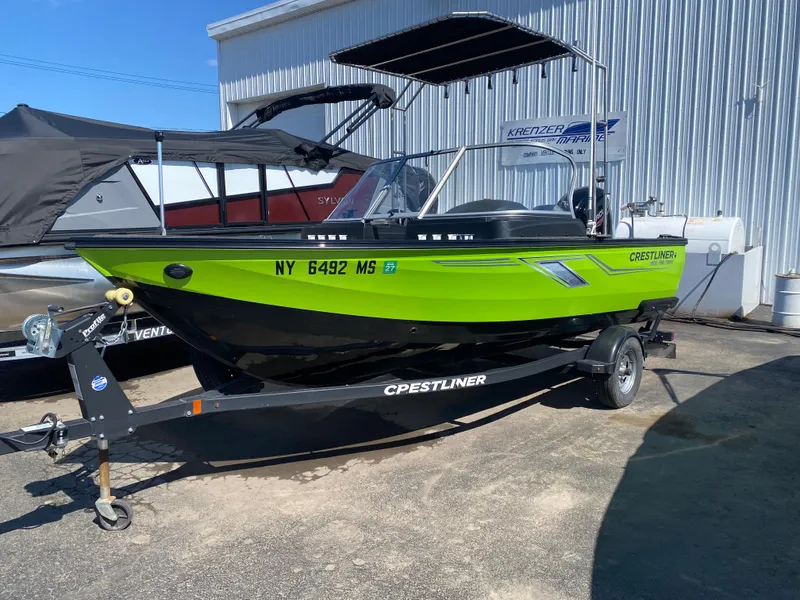 Slide: The Image of 2021 Crestliner FishHawk 1650 boat in vibrant green, parked on a trailer. - 1