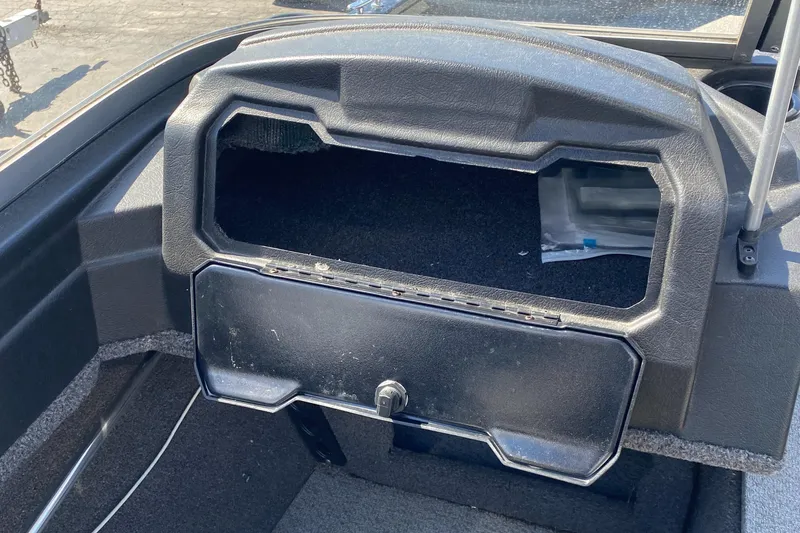 Slide: The Image of 2021 Crestliner FishHawk 1650 dashboard with open storage compartment. - 10