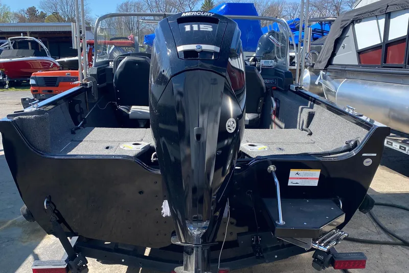 Slide: The Image of 2021 Crestliner FishHawk 1650 boat with Mercury 115 engine, rear view in marina setting. - 7