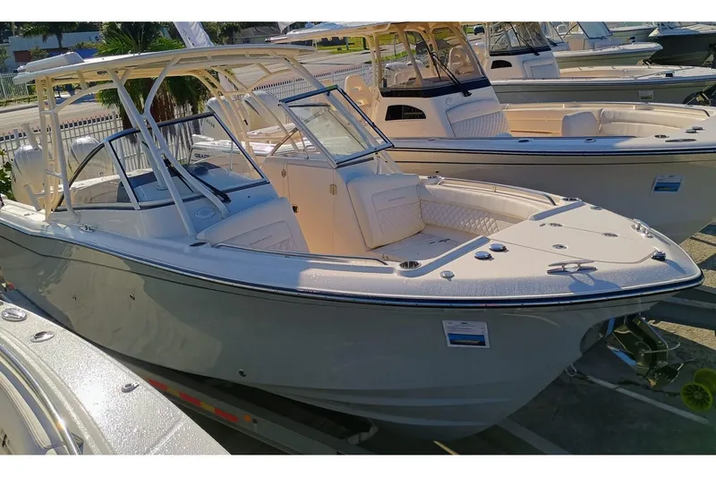 Slide: The Image of 2025 Grady-White Freedom 275 boat displayed at a marina. - 0