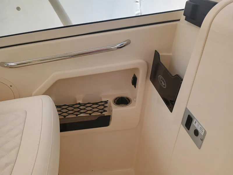 Slide: The Image of Interior of 2025 Grady-White Freedom 275 boat, featuring storage and seating area. - 13