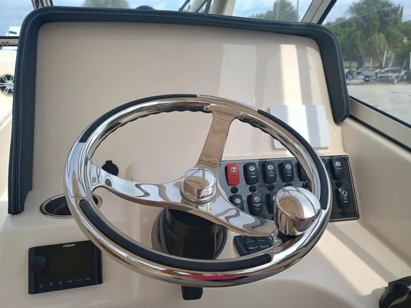 Slide: The Image of Steering wheel and controls of 2025 Grady-White Freedom 275 boat. - 19