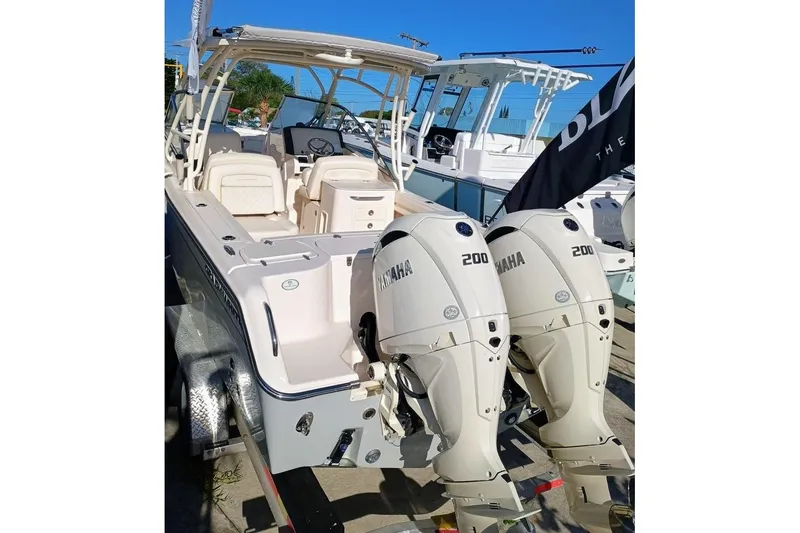 Slide: The Image of 2025 Grady-White Freedom 275 boat with dual Yamaha 200 engines, docked outdoors. - 25