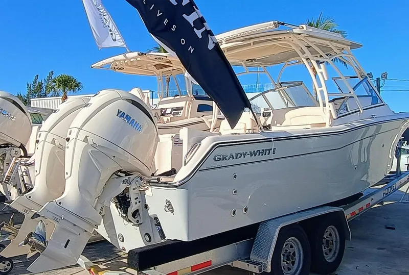 Slide: The Image of 2025 Grady-White Freedom 275 boat on trailer with Yamaha engines, displayed outdoors. - 3