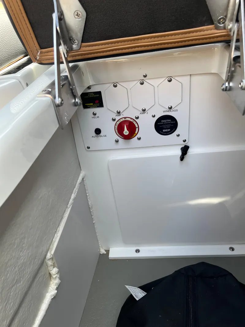 Slide: The Image of Control panel of 2025 Crownline Eclipse E235 boat, featuring switches and a red knob. - 4