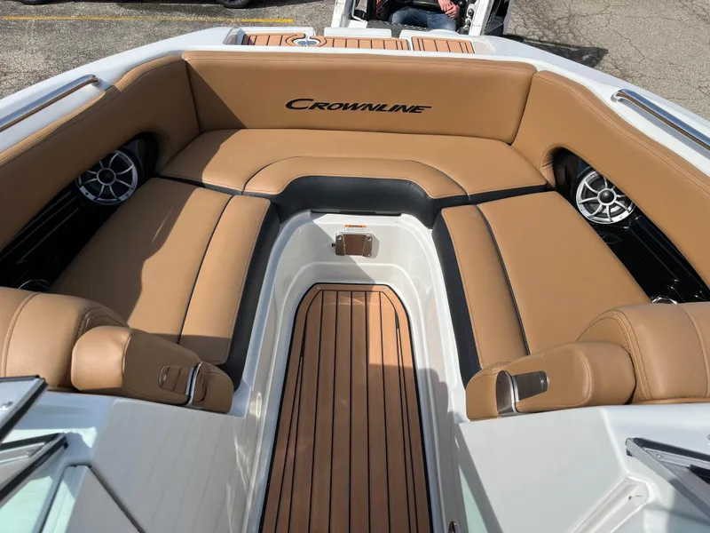 Slide: The Image of 2025 Crownline Eclipse E235 boat interior with tan leather seating and wood flooring. - 9