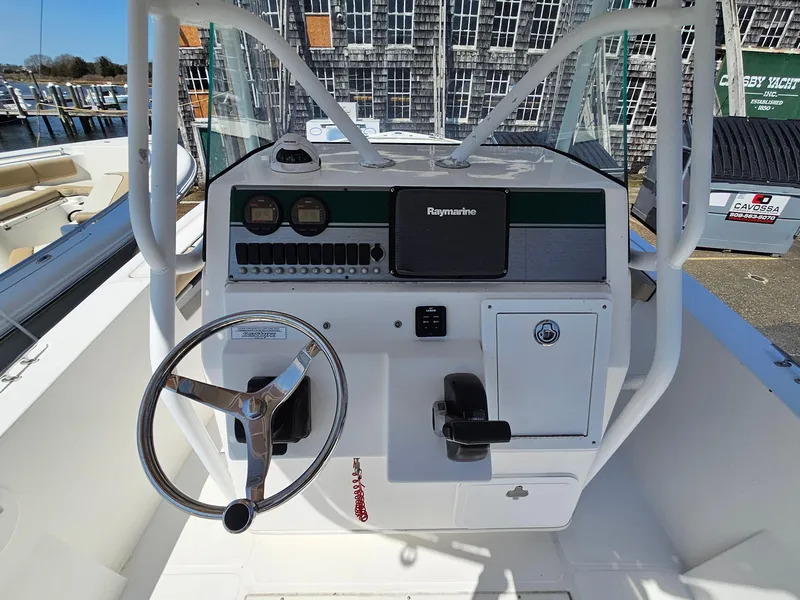 Slide: The Image of 2007 Seastrike 220 B boat console with steering wheel and Raymarine navigation system. - 11