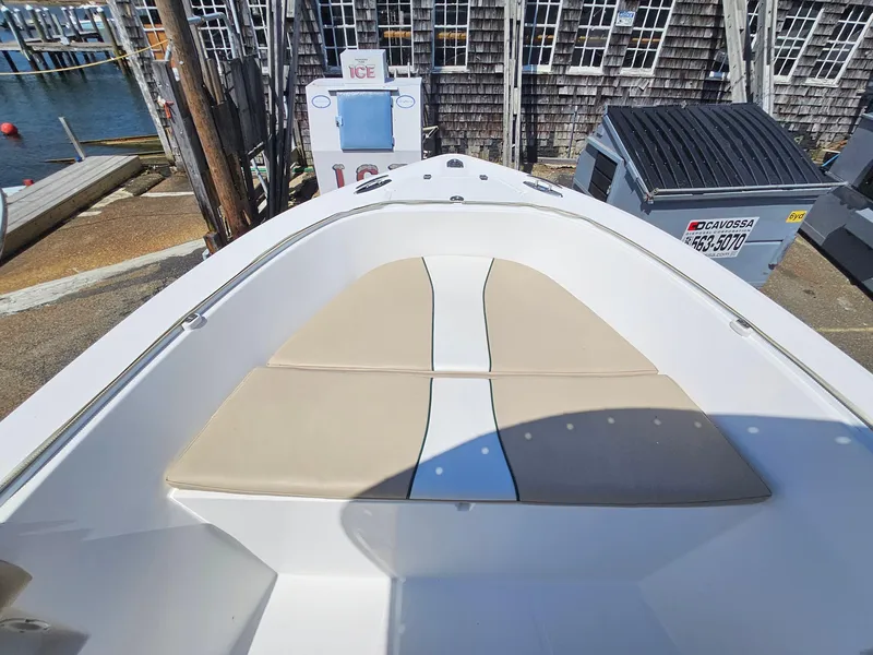 Slide: The Image of 2007 Seastrike 220 B boat with beige seating, docked near a marina. - 13