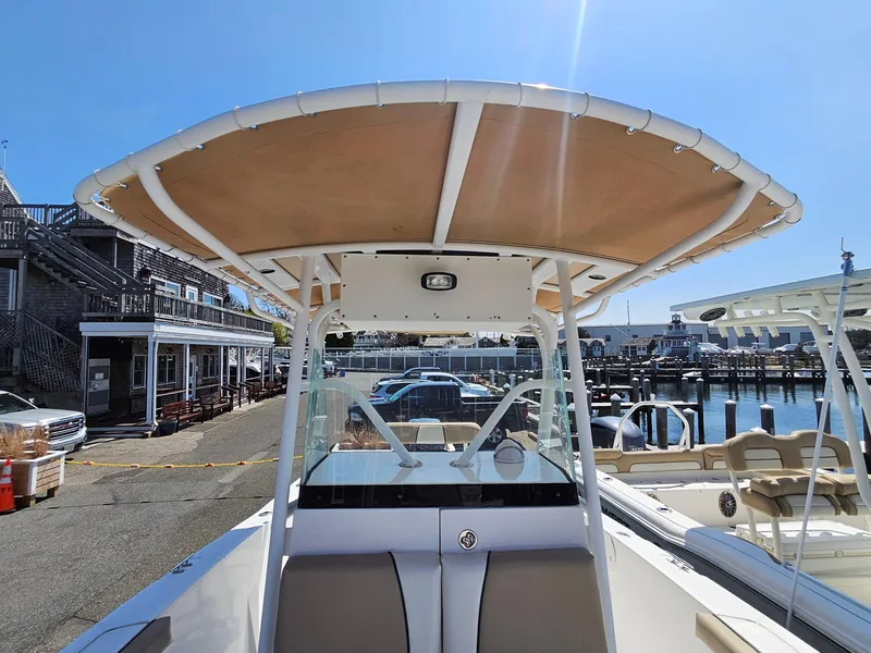 Slide: The Image of 2007 Seastrike 220 B boat docked at marina, featuring a sturdy T-top and clear windshield. - 15
