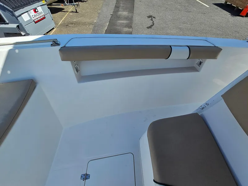 Slide: The Image of Interior view of a 2007 Seastrike 220 B boat, featuring cushioned seating and storage compartment. - 17