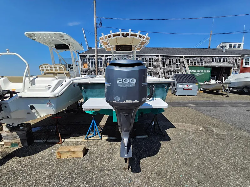 Slide: The Image of 2007 Seastrike 220 B boat with 200 HP outboard motor, parked outdoors. - 3