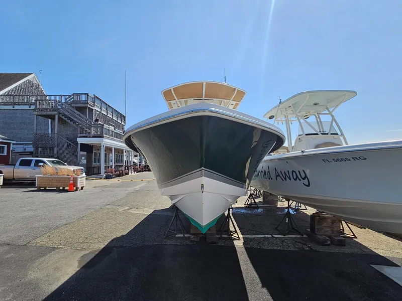 Slide: The Image of 2007 Seastrike 220 B boat on dry dock, with neighboring vessel and coastal buildings. - 5