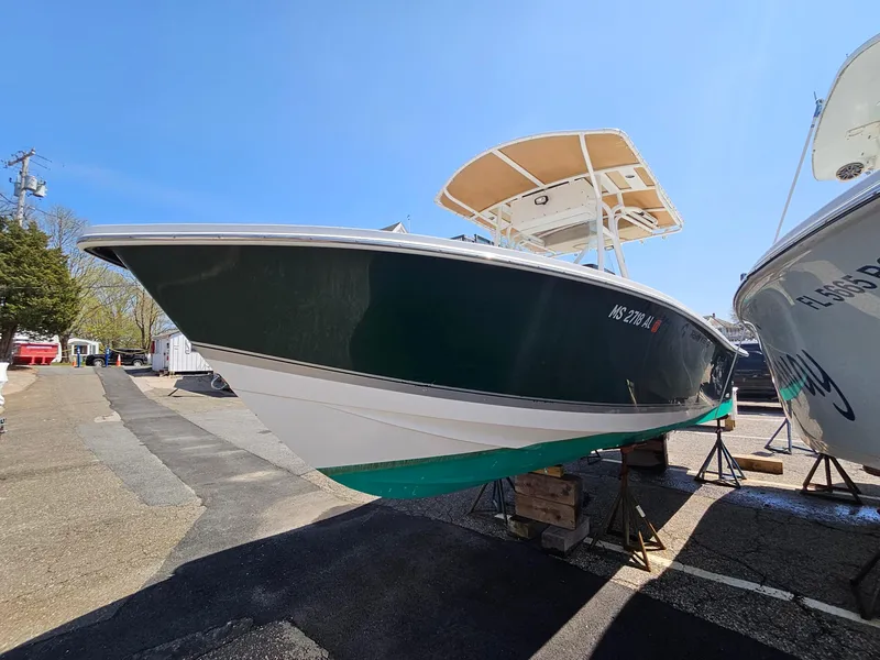 Slide: The Image of 2007 Seastrike 220 B boat with green hull, docked on land under clear blue sky. - 6