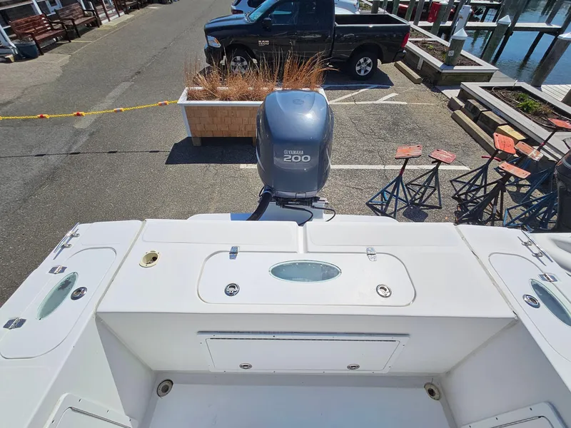 Slide: The Image of 2007 Seastrike 220 B boat with Yamaha 200 engine, docked near a parking area. - 7