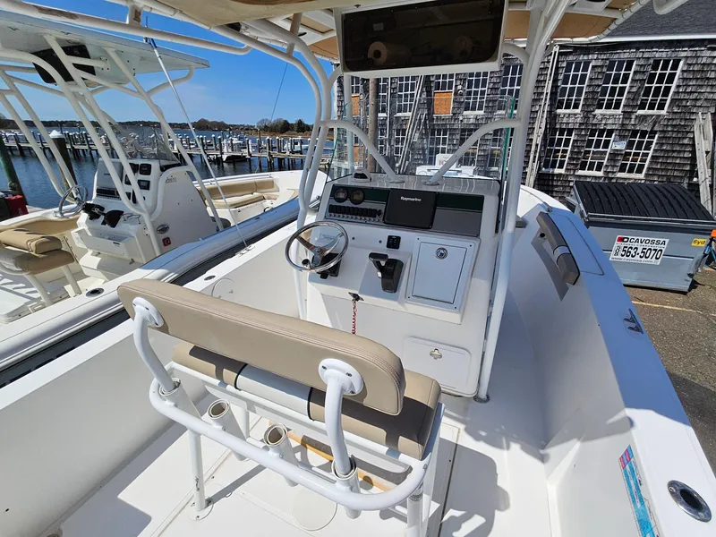 Slide: The Image of 2007 Seastrike 220 B boat interior with steering console and seating at a marina. - 8