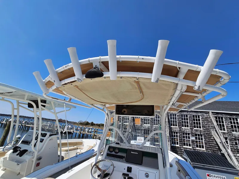 Slide: The Image of 2007 Seastrike 220 B boat with T-top and rod holders, docked under clear blue sky. - 9