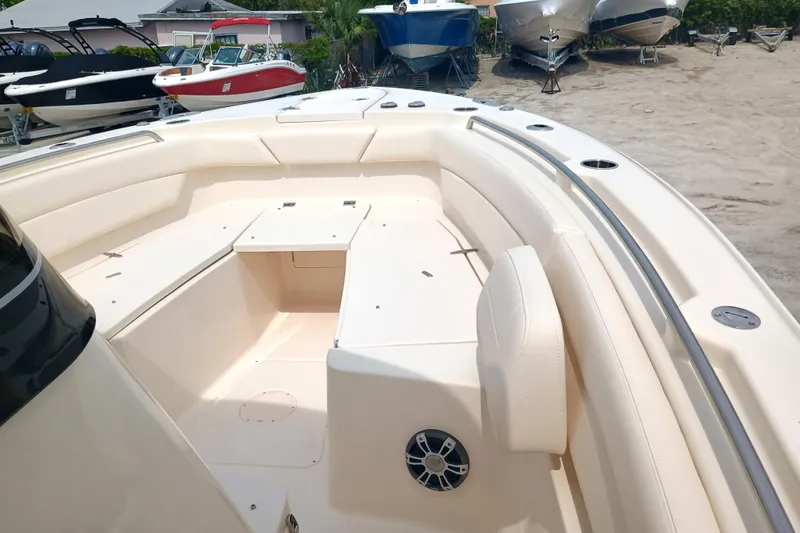 Slide: The Image of 2025 Grady-White Canyon 271 boat interior with spacious seating and storage on sandy shore. - 17