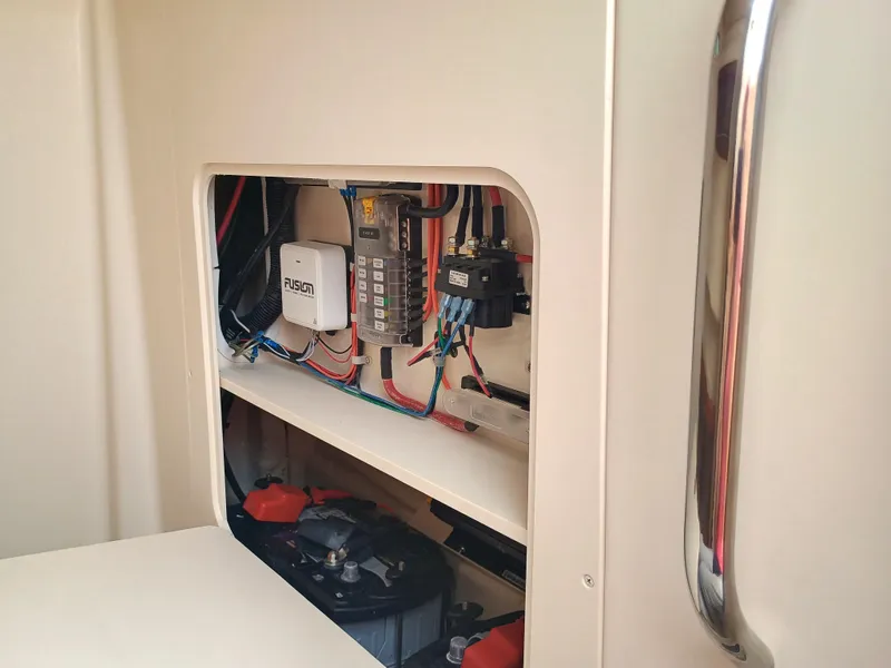 Slide: The Image of Electrical panel inside 2025 Grady-White Canyon 271 boat, showcasing wiring and components. - 21