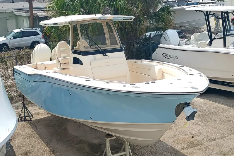 Slide: The Image of 2025 Grady-White Canyon 271 boat in light blue, docked outdoors. - 3