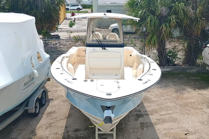 Slide: The Image of 2025 Grady-White Canyon 271 boat, docked, front view, in a sunny outdoor setting. - 5