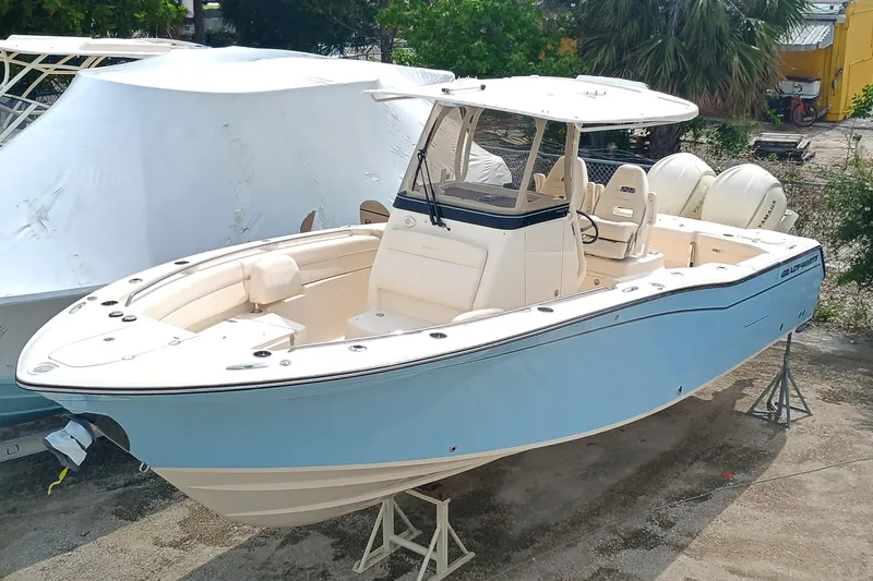 Slide: The Image of 2025 Grady-White Canyon 271 boat in light blue, docked outdoors. - 7