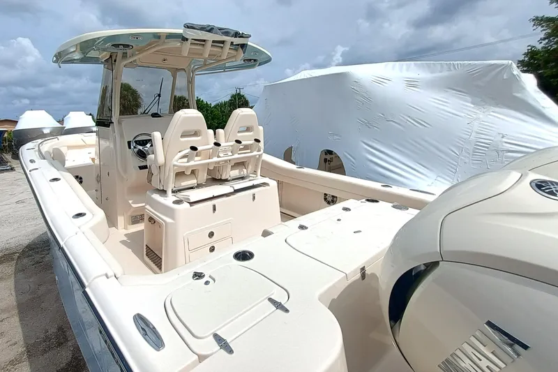 Slide: The Image of 2025 Grady-White Canyon 271 boat with dual seats and covered engine, docked outdoors. - 8