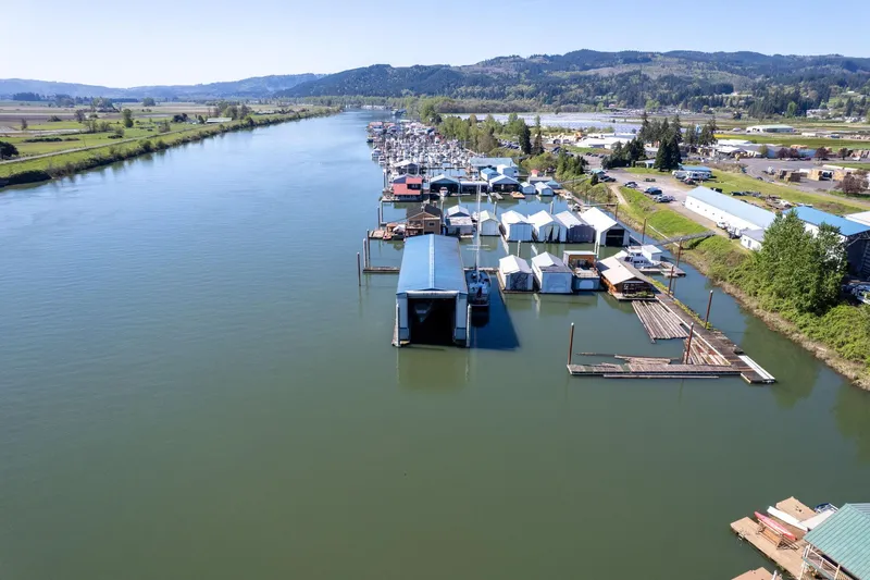 Slide: The Image of Aerial view of Larson Boathouse, 1985, along a scenic river with surrounding landscape. - 22