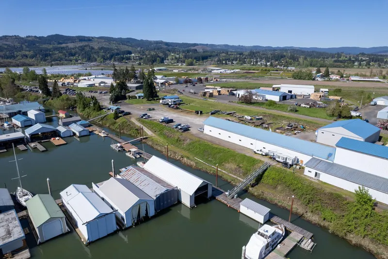 Slide: The Image of Aerial view of Larson Boathouse, 1985, with surrounding landscape and waterway. - 27