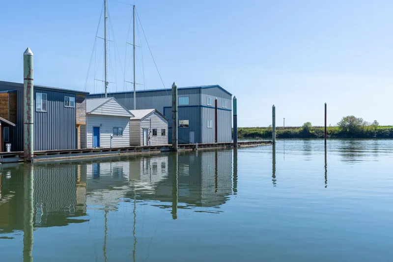 Slide: The Image of Boathouse on calm water, clear sky, Custom Larson Boathouse, 1985. - 33