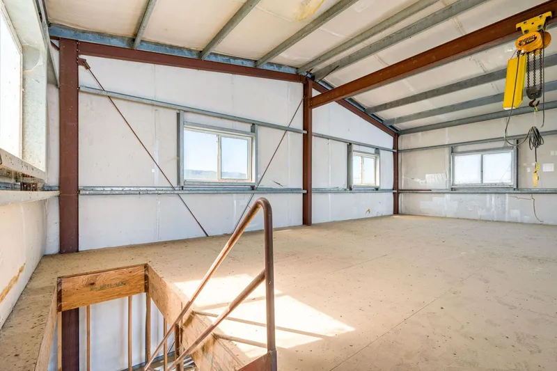 Slide: The Image of Spacious interior of 1985 Custom Larson Boathouse with metal beams and windows. - 8