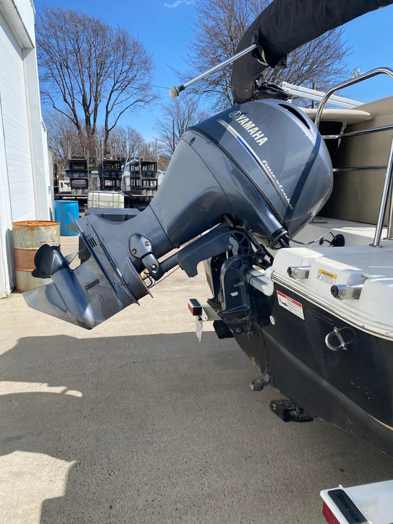 Slide: The Image of 2014 Hurricane Fundeck 216 boat with Yamaha outboard motor, parked outdoors. - 10