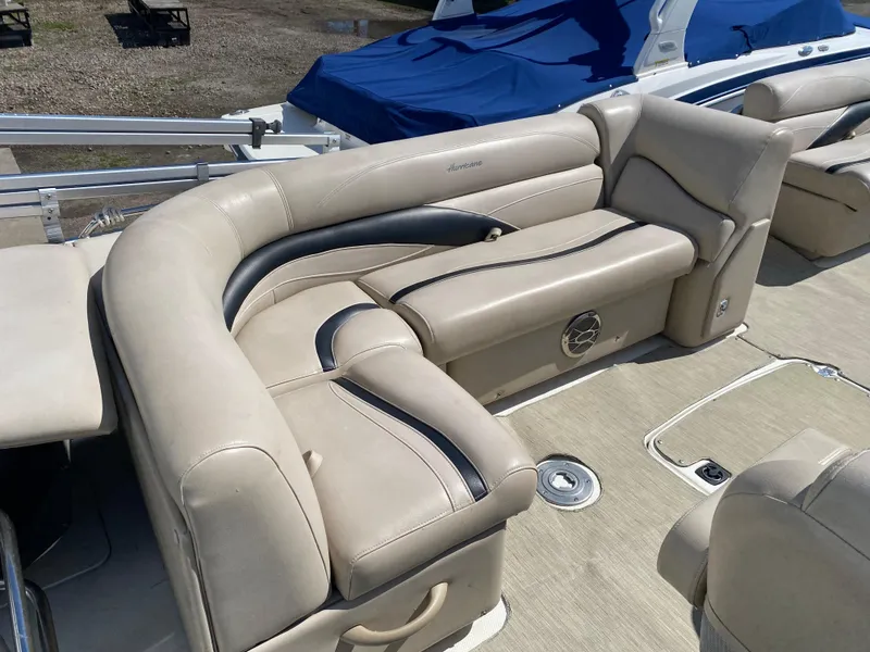 Slide: The Image of 2014 Hurricane Fundeck 216 boat with beige leather seating and blue cover. - 2
