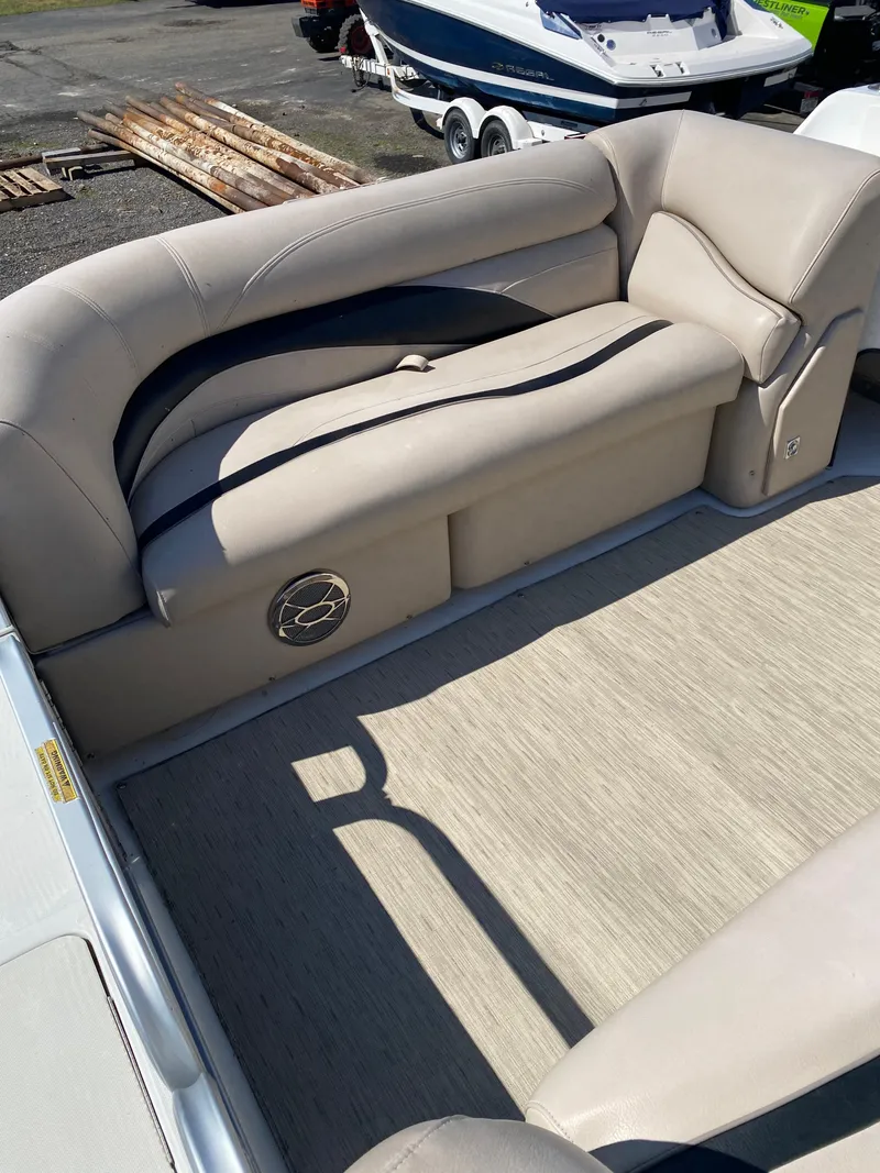 Slide: The Image of 2014 Hurricane Fundeck 216 boat interior with beige seating and carpeted floor. - 6