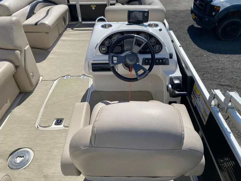 Slide: The Image of 2014 Hurricane Fundeck 216 boat interior with steering wheel and seating. - 8