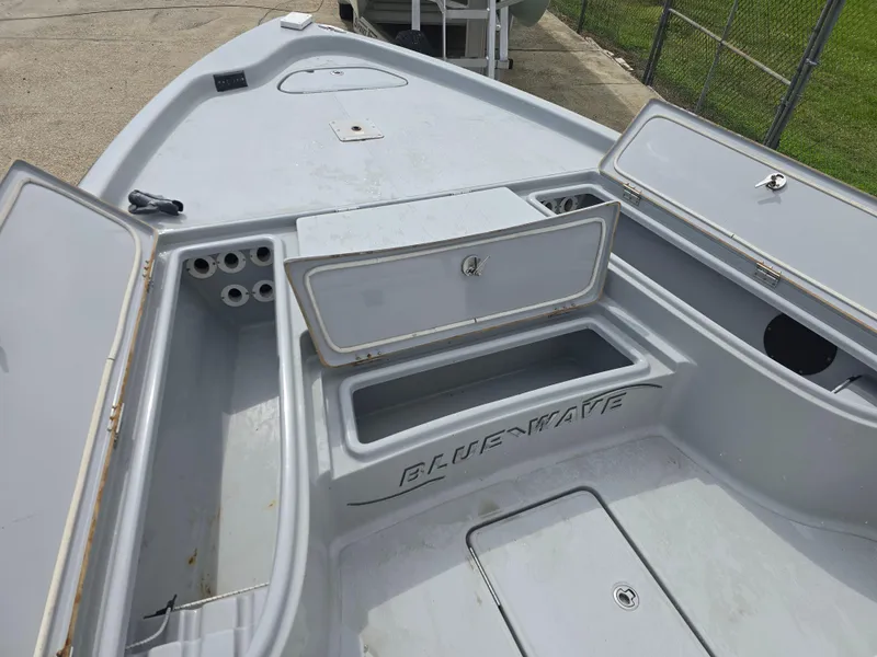 Slide: The Image of 2016 Blue Wave 2400 PureBay boat with open storage compartments on deck. - 15