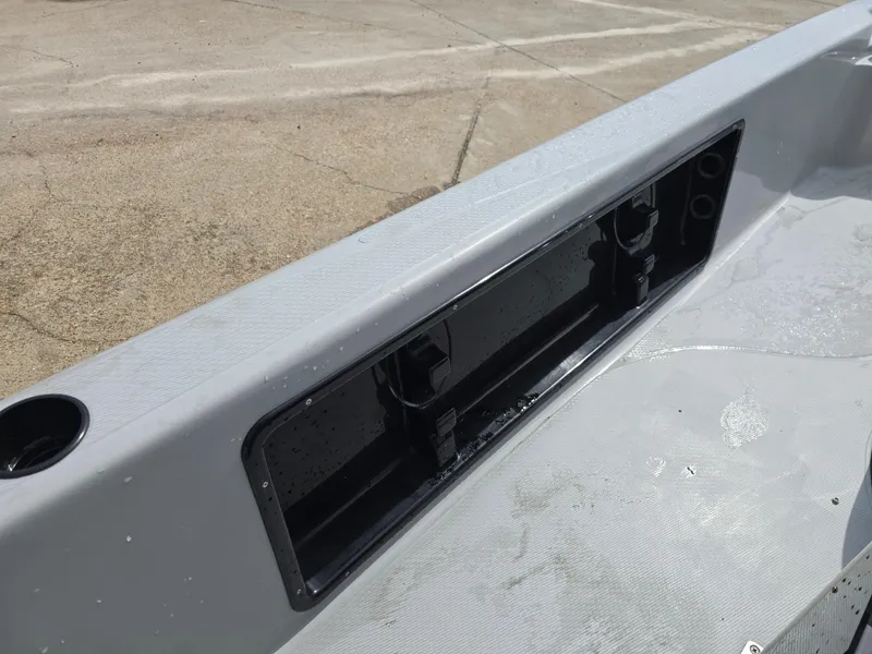 Slide: The Image of 2016 Blue Wave 2400 PureBay boat interior with storage compartment and cup holder. - 17