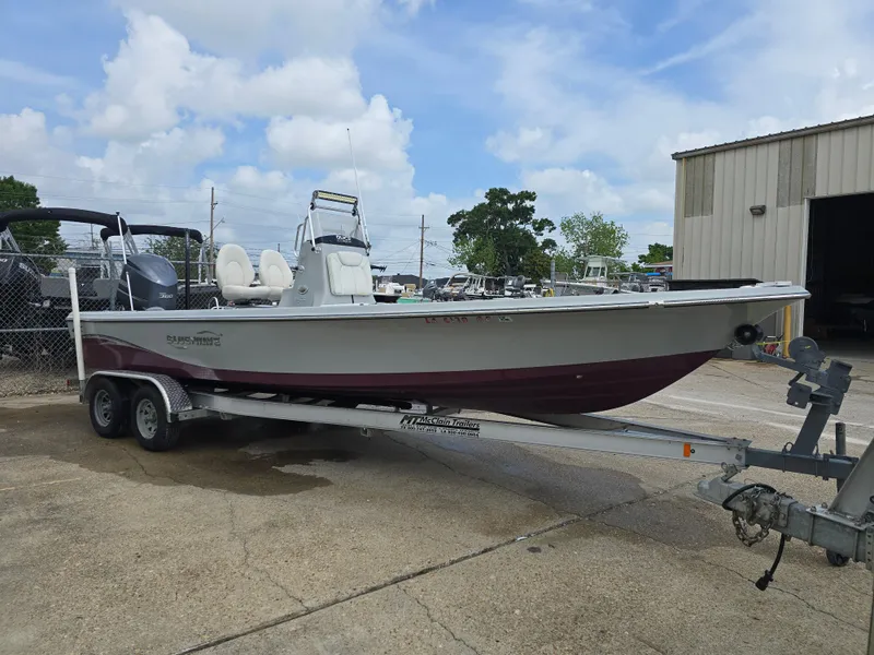 Slide: The Image of 2016 Blue Wave 2400 PureBay boat on trailer, parked outdoors near a building. - 7