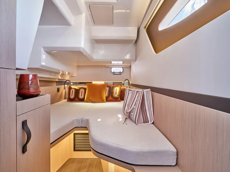 Slide: The Image of 2023 Four Winns TH36 OB cabin interior with cozy seating and modern design. - 12