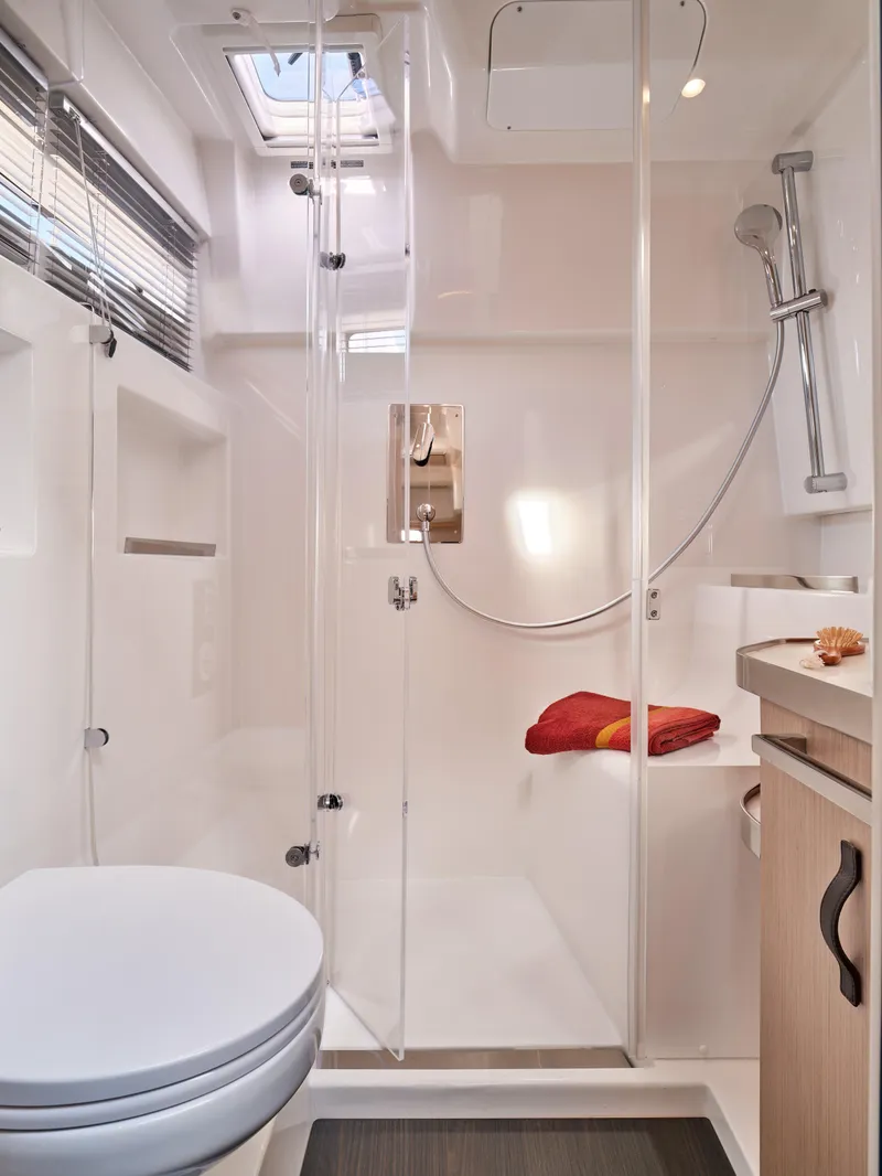 Slide: The Image of 2023 Four Winns TH36 OB bathroom with shower, toilet, and modern fixtures. - 13