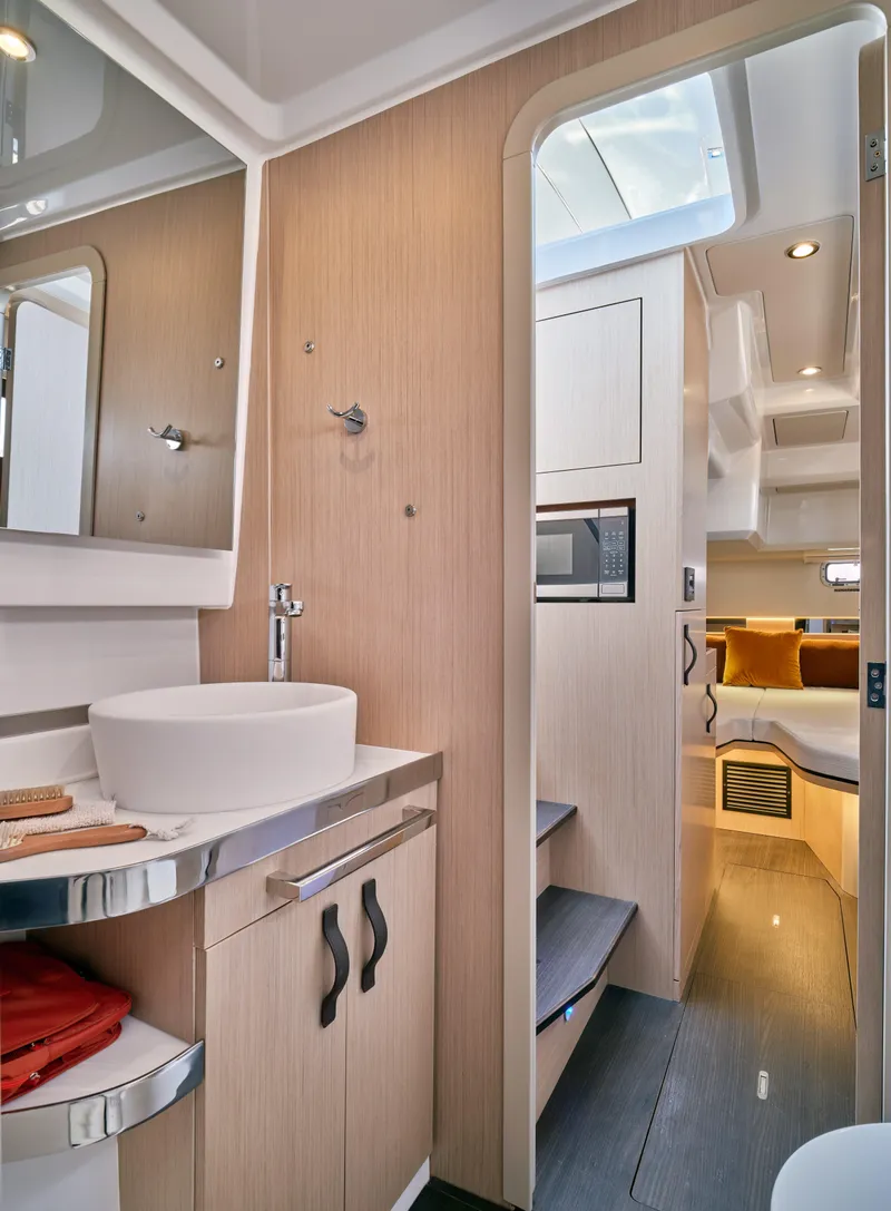 Slide: The Image of 2023 Four Winns TH36 OB interior with modern bathroom and cozy cabin. - 15