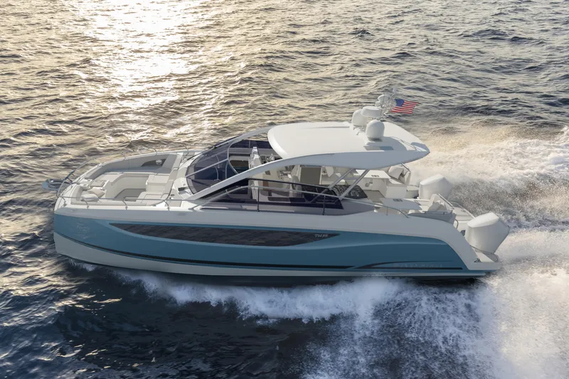 Slide: The Image of 2023 Four Winns TH36 OB cruising on open water, showcasing sleek design and powerful performance. - 2