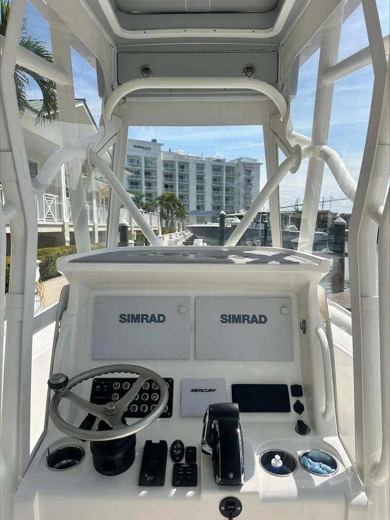 Slide: The Image of 2024 SeaVee 270Z boat console with Simrad electronics and Mercury controls. - 4