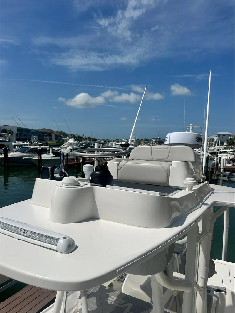 Slide: The Image of 2024 SeaVee 270Z boat docked at marina under clear blue sky. - 5