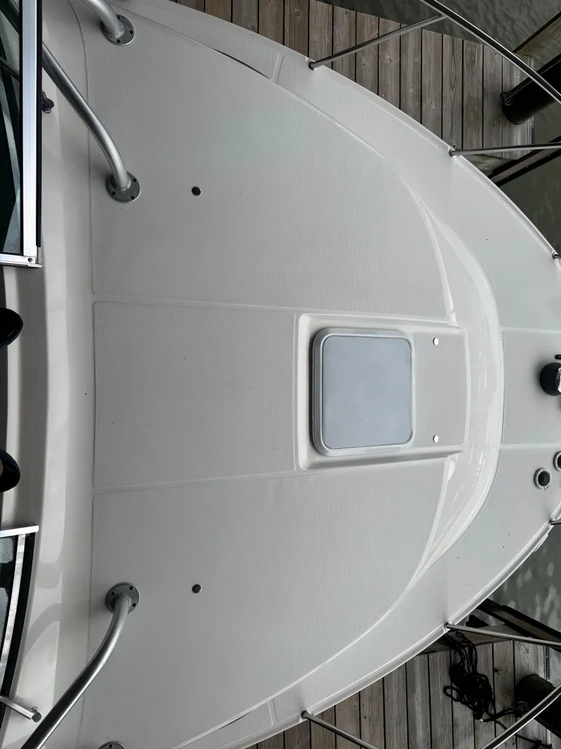 Slide: The Image of 2004 Wellcraft 290 Coastal boat deck with textured surface and hatch. - 15
