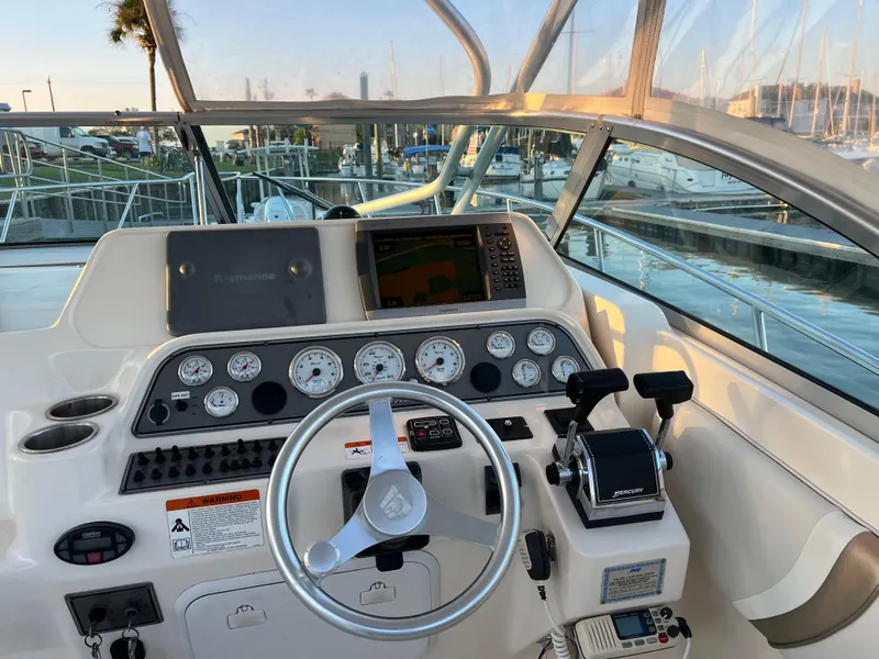 Slide: The Image of Helm of 2004 Wellcraft 290 Coastal boat with gauges and controls, docked at marina. - 17